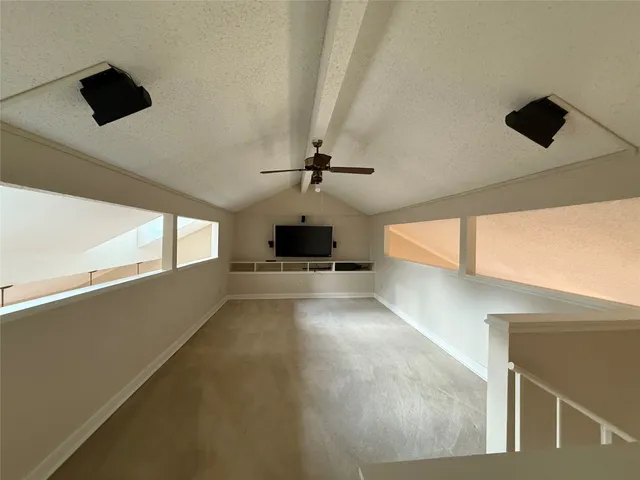 a view of a ceiling fan and window