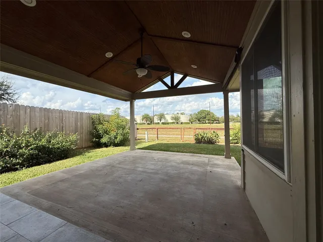 a view of a house with backyard and porch