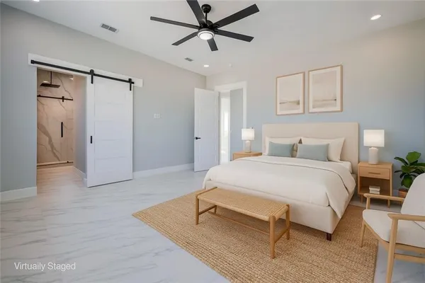 a view of a livingroom with a ceiling fan & entryway