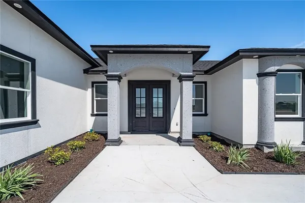 a front view of a house with a yard