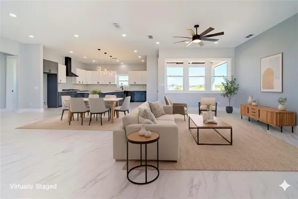 a large kitchen with granite countertop a large counter top stainless steel appliances and cabinets
