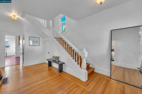 a view of entryway and hall with wooden floor