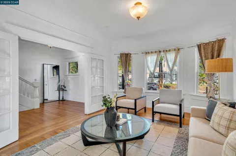 a living room with furniture potted plant and a large window