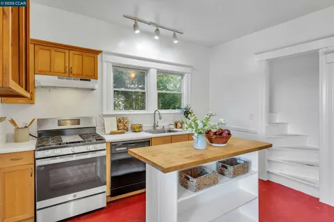 a kitchen with a sink a counter and a large window