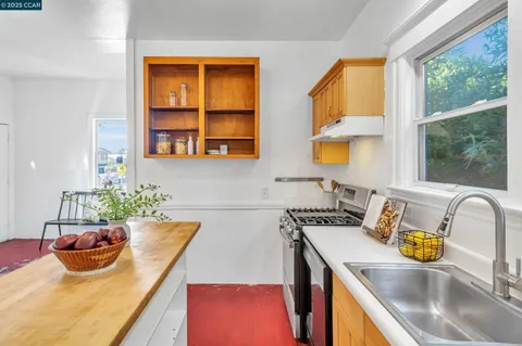 a kitchen with a sink a stove and a window