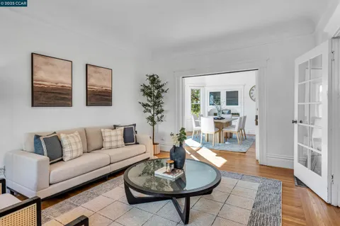 a living room with furniture a rug and a table
