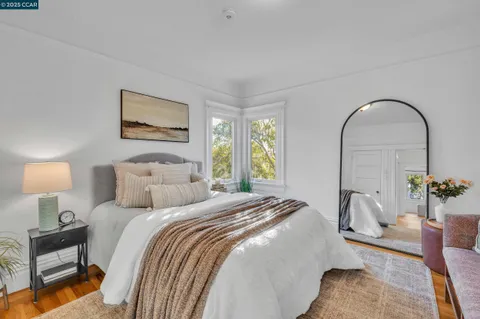 a bedroom with a bed and a painting on the wall