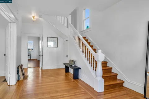 a view of entryway and hall with wooden floor