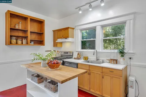 a kitchen with stainless steel appliances a sink a stove and a window