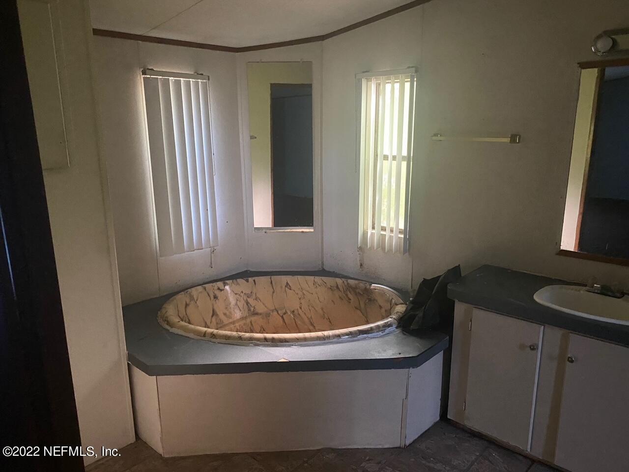 112 Pridgeon Street Interlachen, FL 32148 - Photo 13 of 21 a living room with a sink and a window