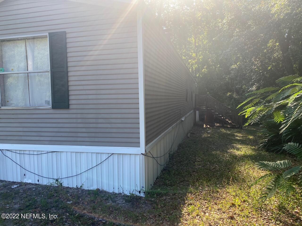 112 Pridgeon Street Interlachen, FL 32148 - Photo 3 of 21 a view of backyard and small cabin