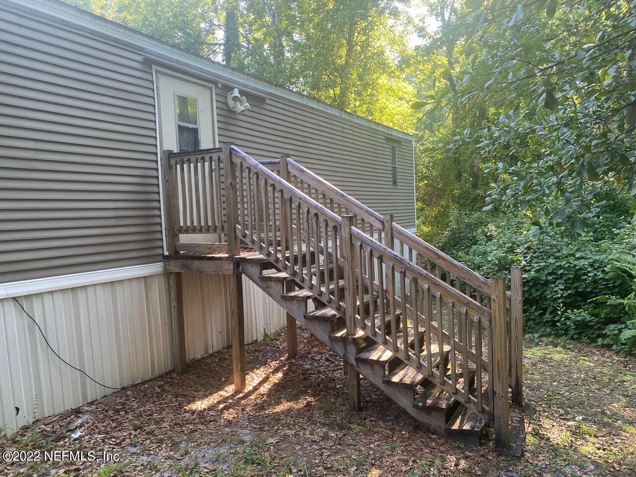 112 Pridgeon Street Interlachen, FL 32148 - Photo 4 of 21 a view of wooden house with a small yard