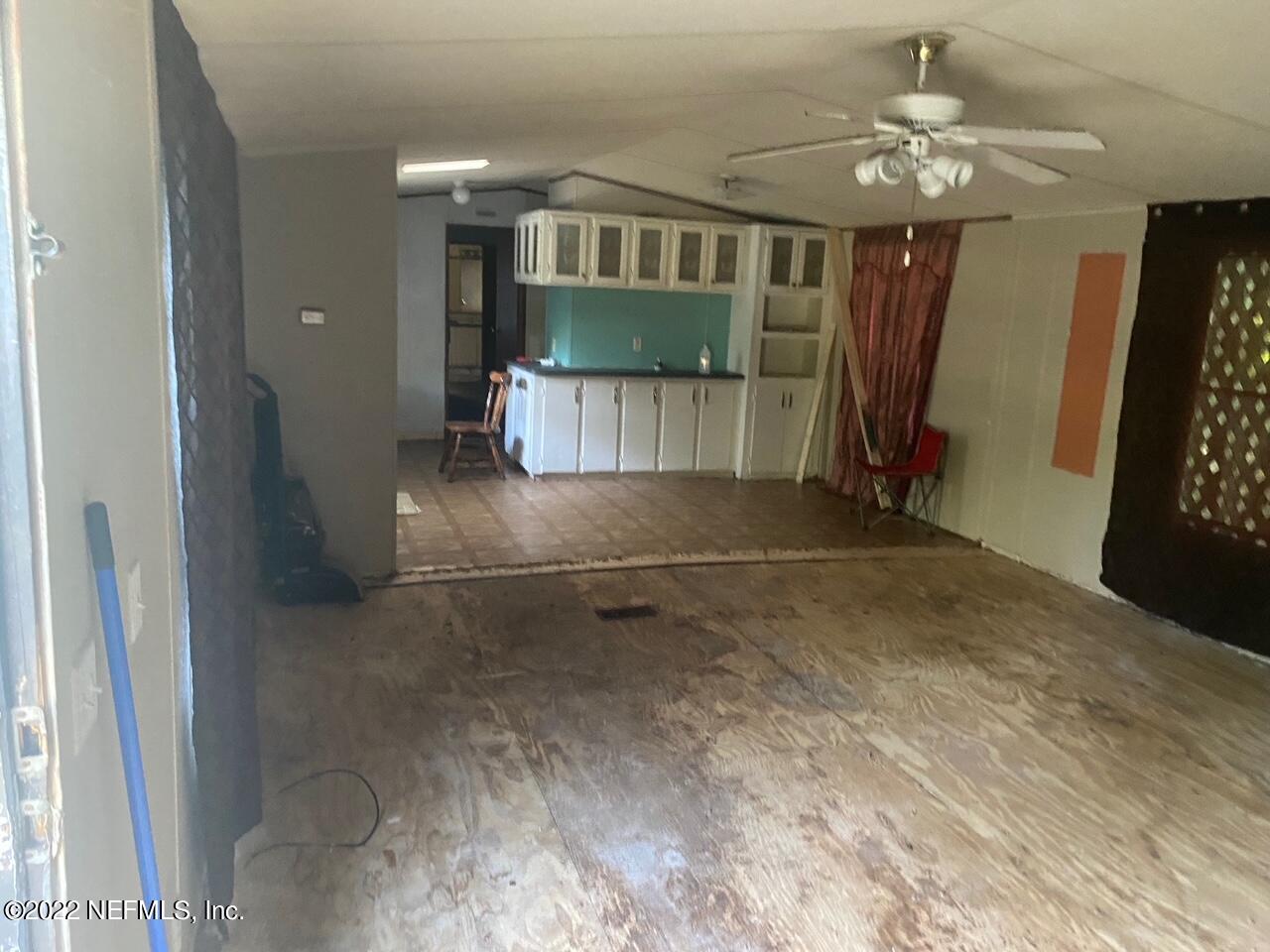 112 Pridgeon Street Interlachen, FL 32148 - Photo 5 of 21 a view of a livingroom with a staircase
