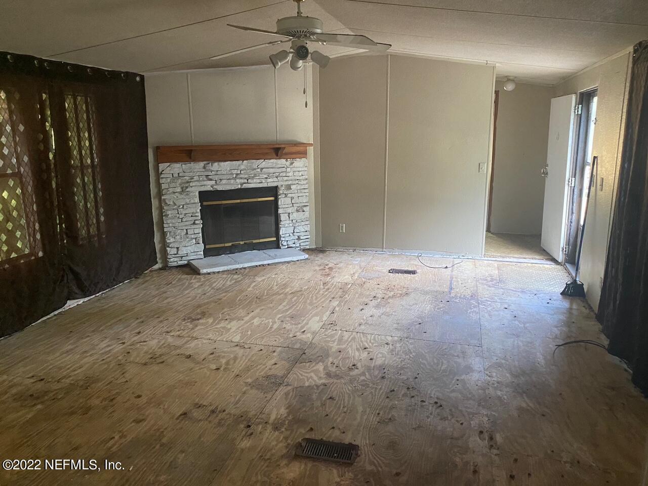 112 Pridgeon Street Interlachen, FL 32148 - Photo 6 of 21 a view of empty room with a fireplace
