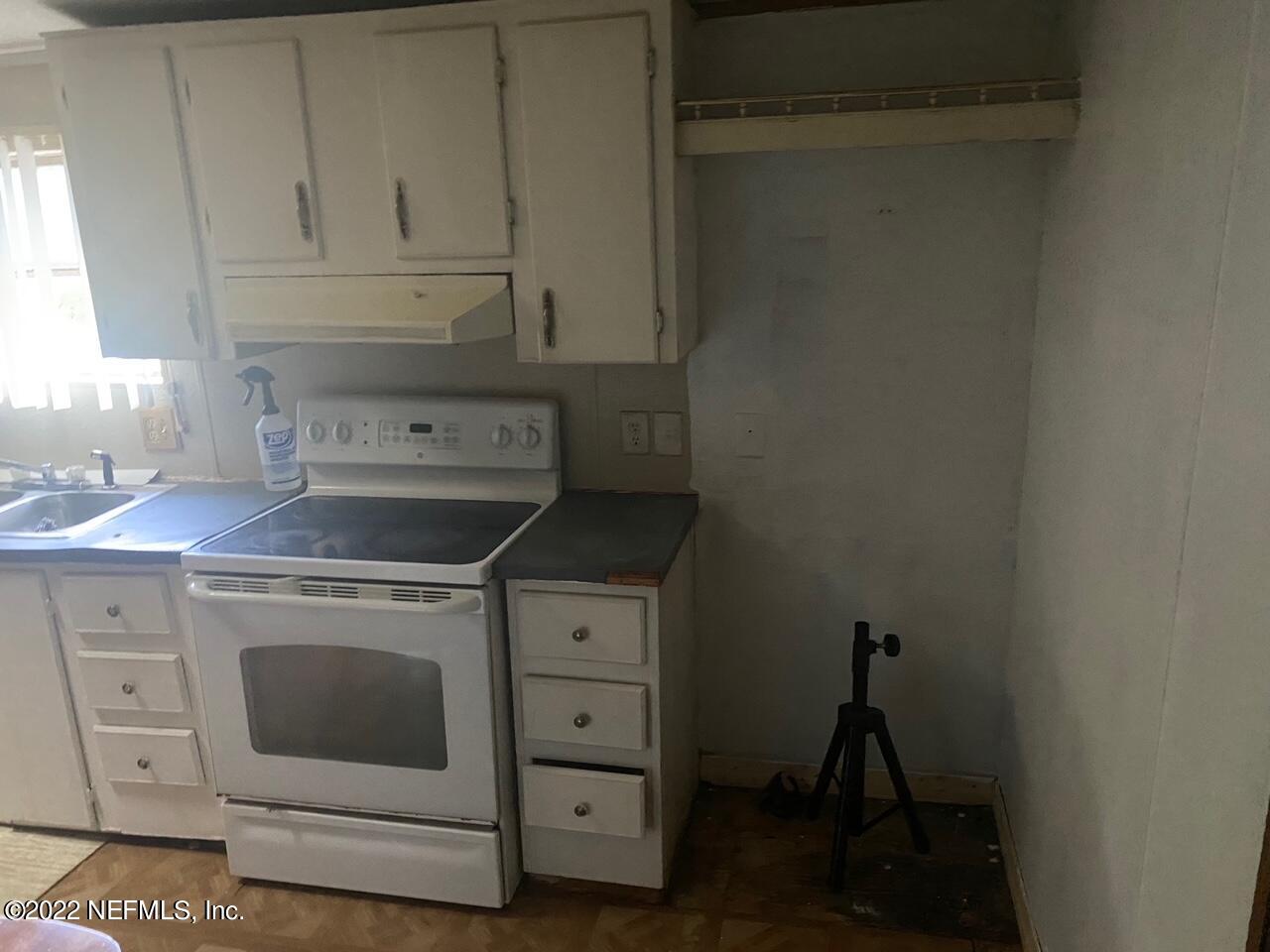 112 Pridgeon Street Interlachen, FL 32148 - Photo 8 of 21 a stove top oven sitting inside of a kitchen