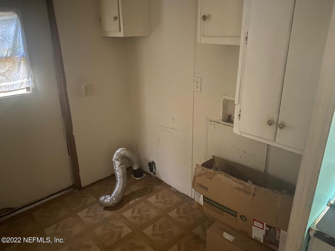 112 Pridgeon Street Interlachen, FL 32148 - Photo 10 of 21 a room with a chair and a window