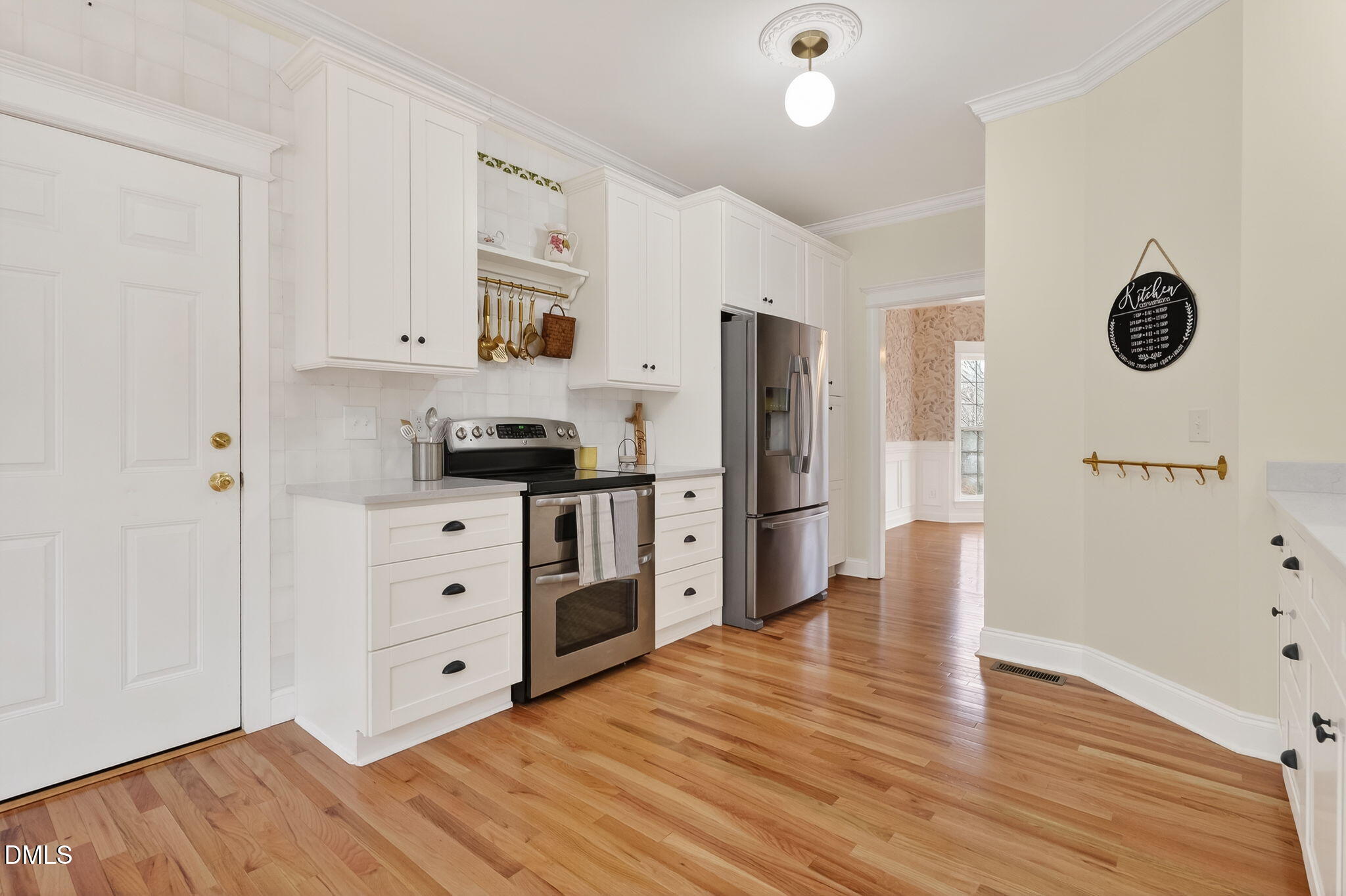 1328 Red Brick Road Garner, NC 27529 - Photo 19 of 64 a kitchen with stainless steel appliances a refrigerator sink and cabinets