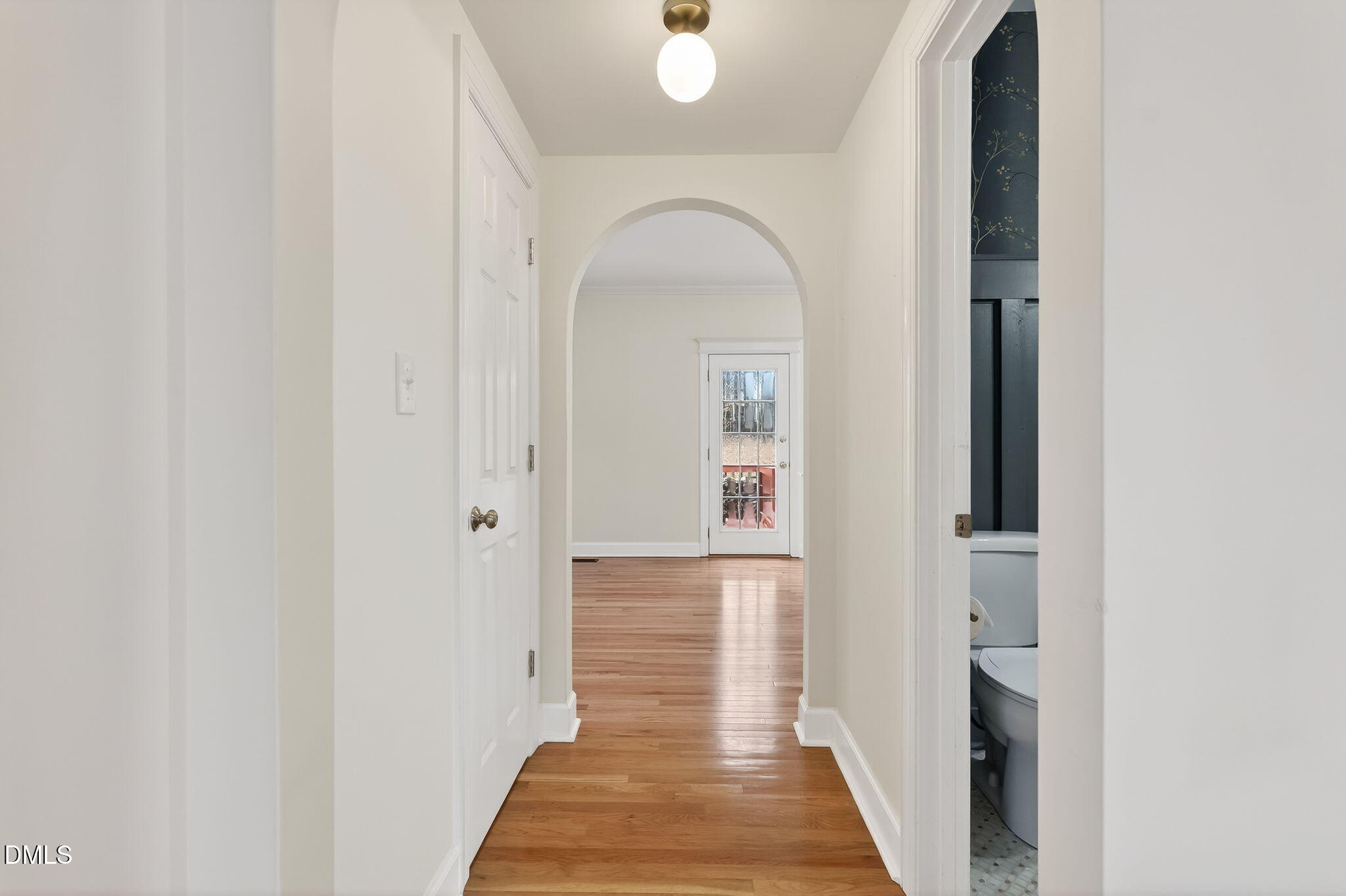 1328 Red Brick Road Garner, NC 27529 - Photo 27 of 64 a view of a hallway with wooden floor and staircase