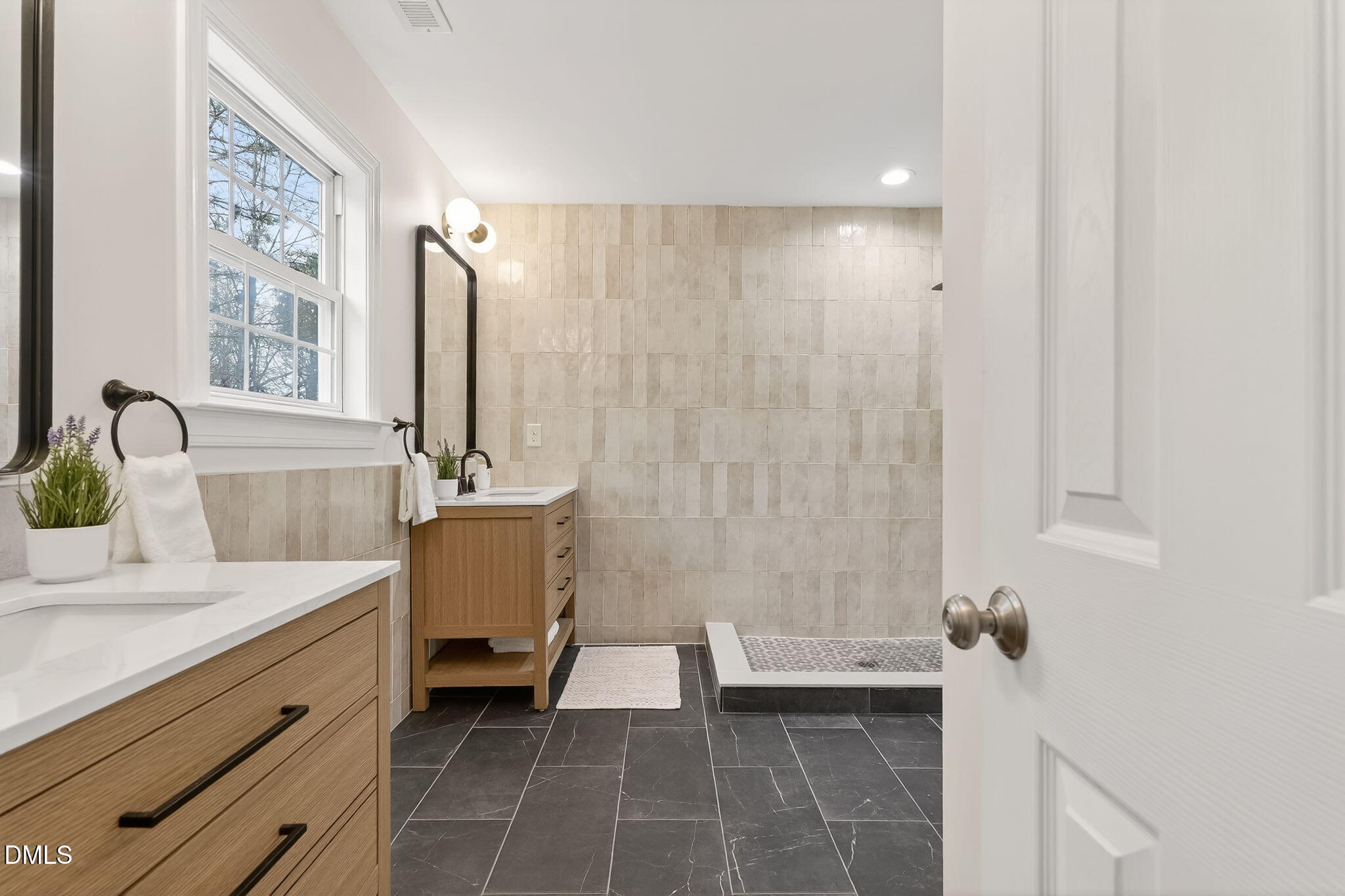 1328 Red Brick Road Garner, NC 27529 - Photo 40 of 64 a bathroom with a double vanity sink and a bathtub