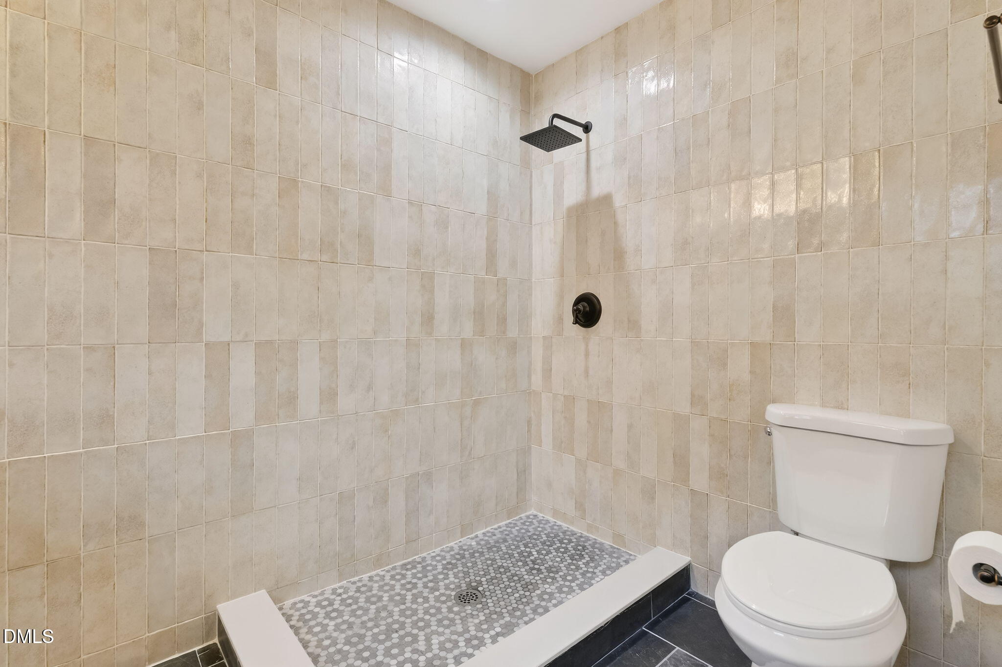 1328 Red Brick Road Garner, NC 27529 - Photo 41 of 64 a white toilet sitting next to a shower curtain