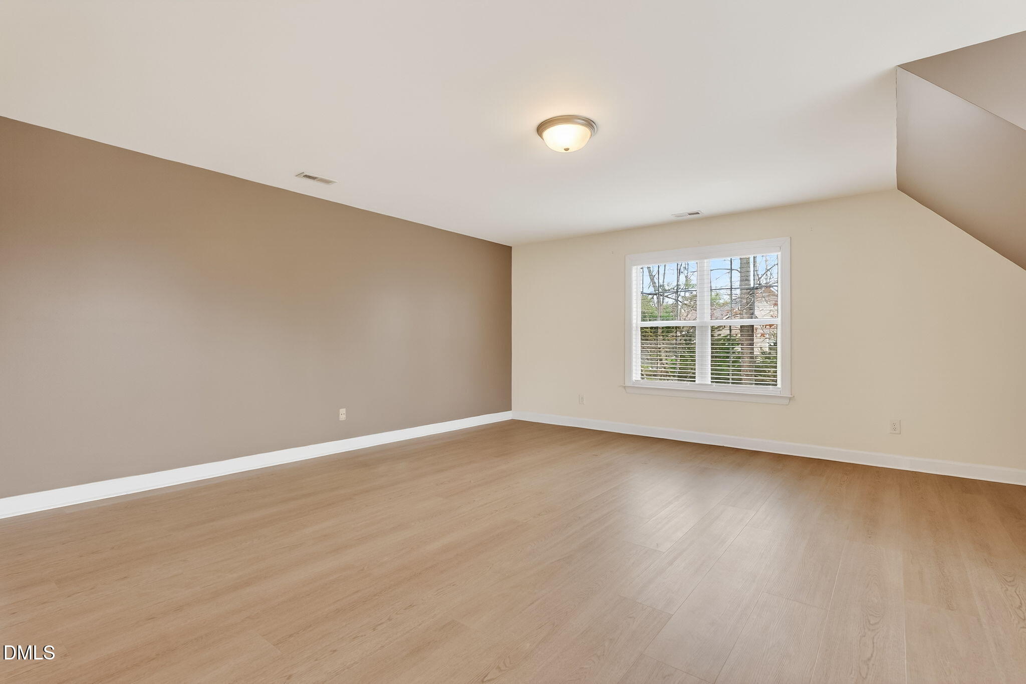 1328 Red Brick Road Garner, NC 27529 - Photo 45 of 64 an empty room with wooden floor and windows