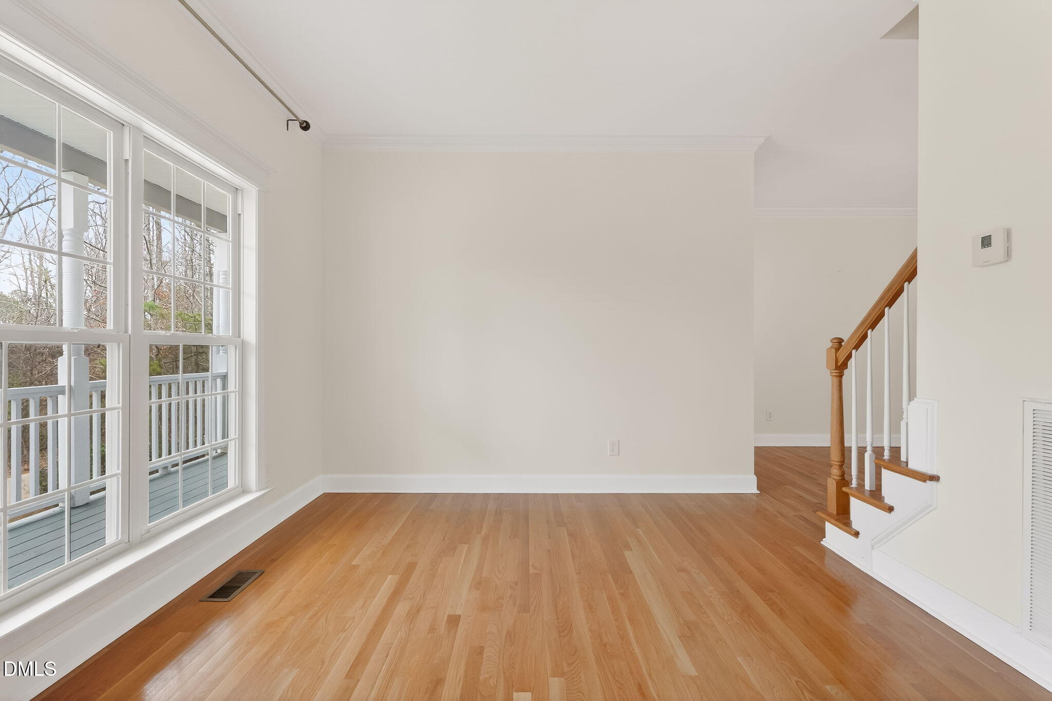 1328 Red Brick Road Garner, NC 27529 - Photo 7 of 64 a view of empty room with wooden floor and fan