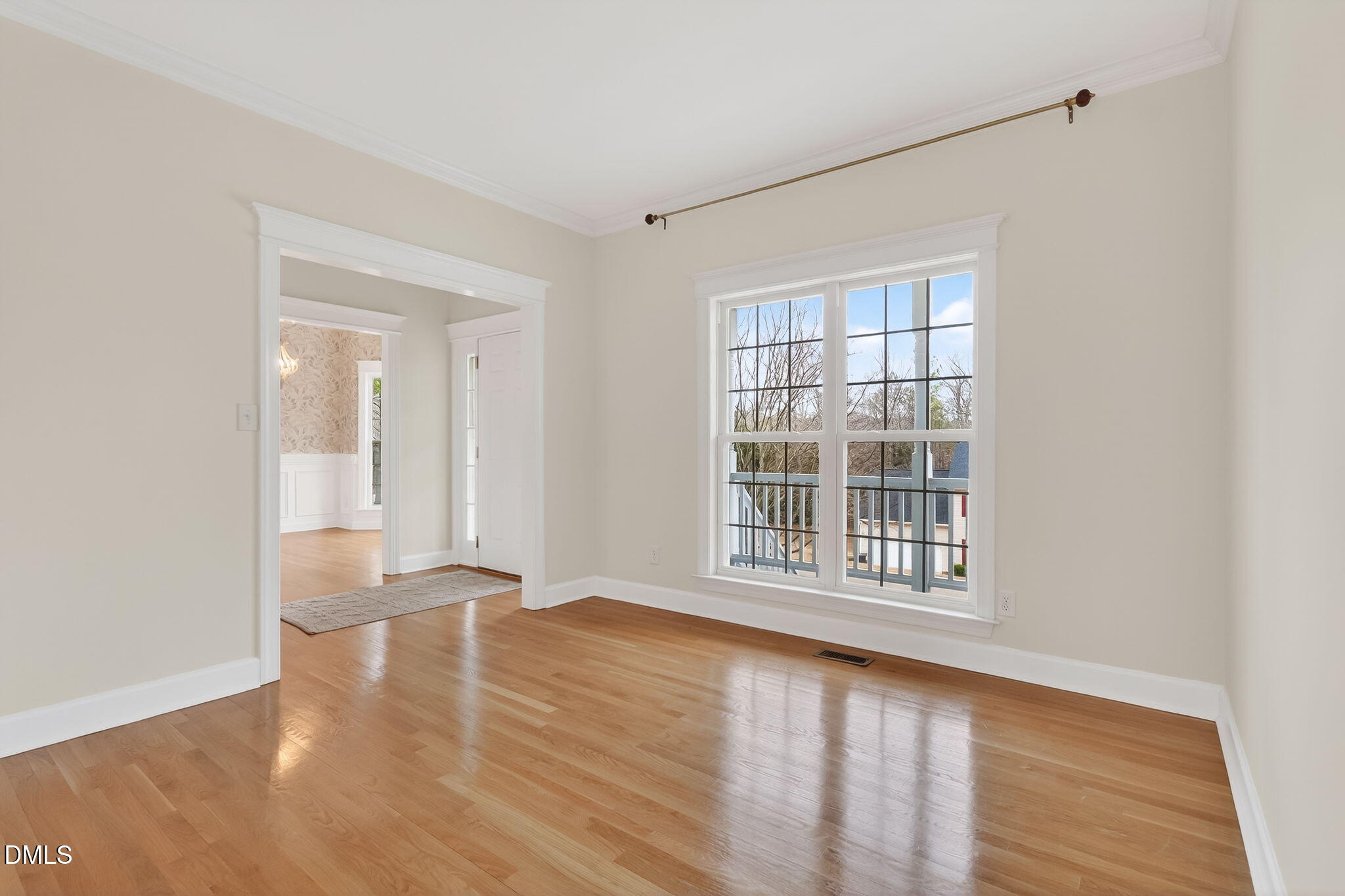 1328 Red Brick Road Garner, NC 27529 - Photo 8 of 64 a view of an empty room with wooden floor and a window
