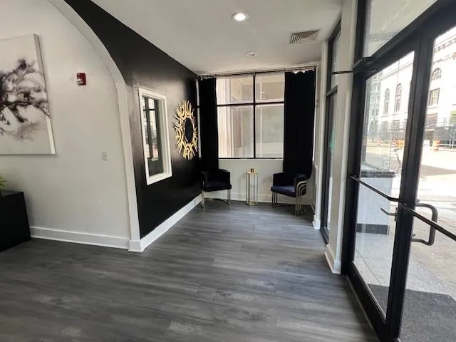 a view of a hallway with wooden floor and glass door