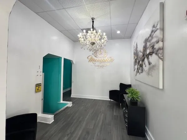 a view of a room with furniture and a chandelier