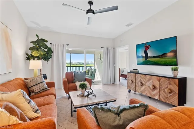 a dining room with furniture a chandelier and window