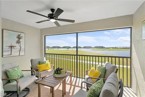 a living room with furniture ceiling fan and a rug