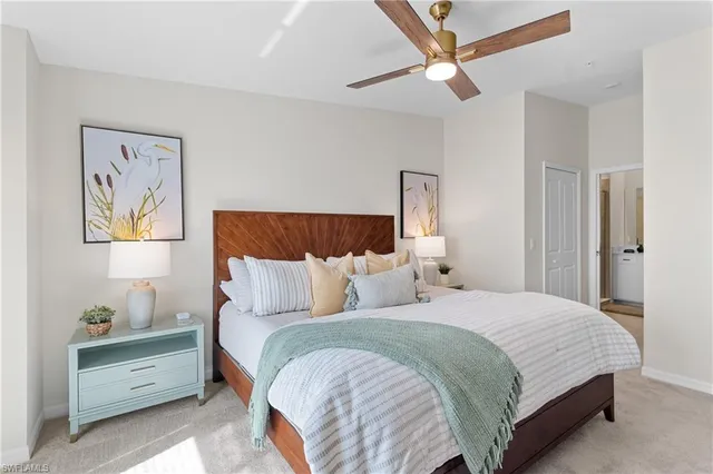 a bedroom with a bed a couch and a window