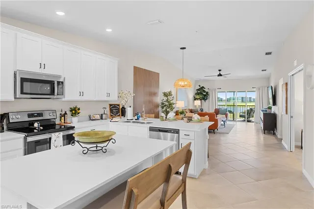 a dining room with furniture a fireplace and a chandelier