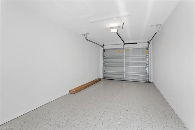 a bedroom with a baby bed dresser and a window