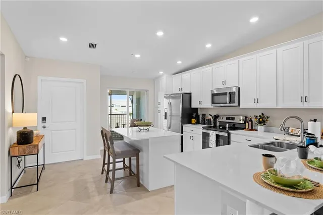 a kitchen with a stove a refrigerator and a stove top oven