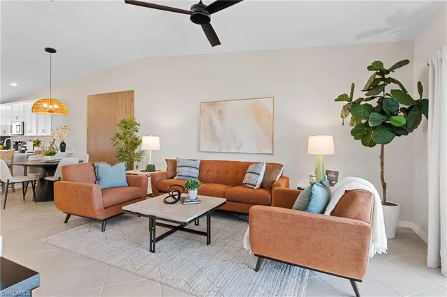 a kitchen with stainless steel appliances kitchen island granite countertop a table and chairs in it