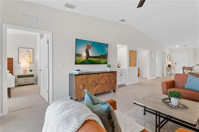 a kitchen with stainless steel appliances kitchen island granite countertop a dining table chairs and white cabinets