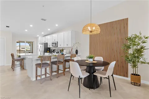 a living room with furniture flowers and a chandelier