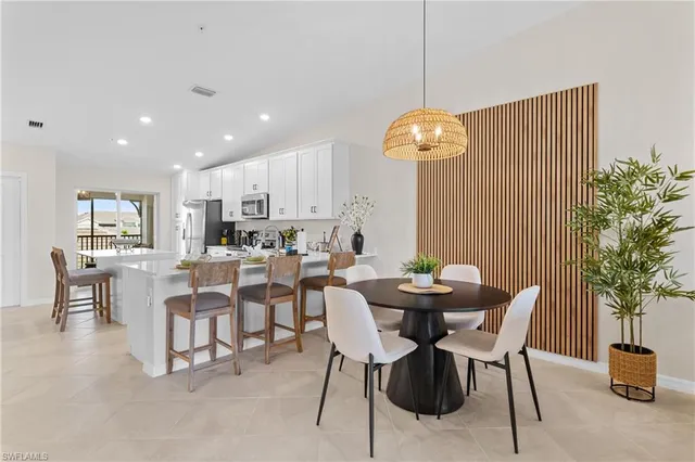 a living room with furniture flowers and a chandelier