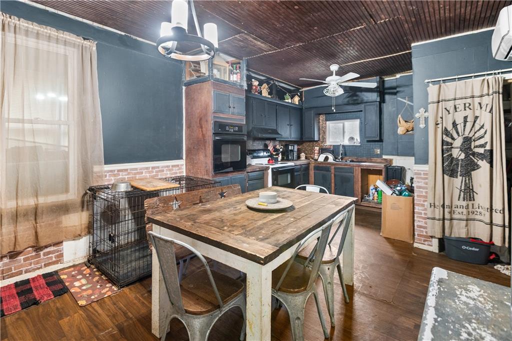 845 Mottern Road Punxsutawney, PA 15767 - Photo 14 of 40 a kitchen with stainless steel appliances granite countertop a stove a refrigerator and a dining table with wooden floor
