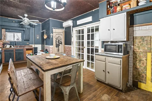 a kitchen with a table chairs and microwave