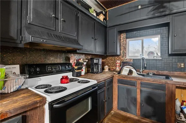 a kitchen with stainless steel appliances granite countertop a stove and a sink