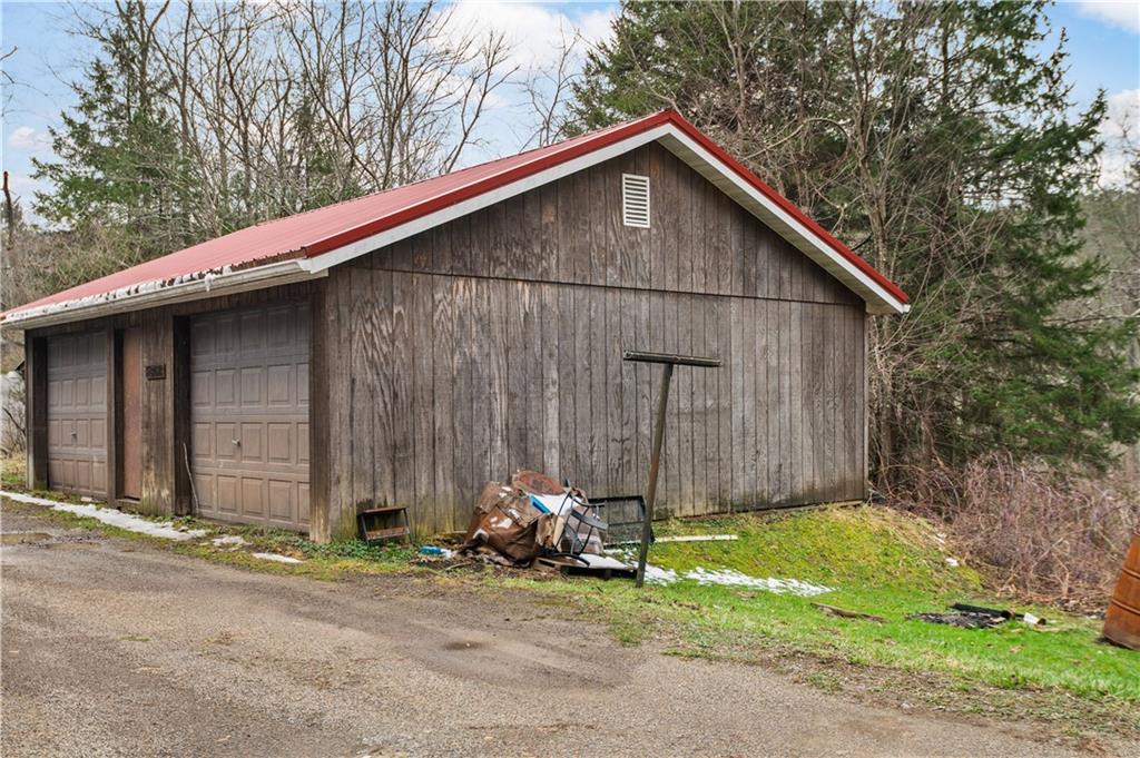 845 Mottern Road Punxsutawney, PA 15767 - Photo 6 of 40 a view of a house with a small yard plants and large tree