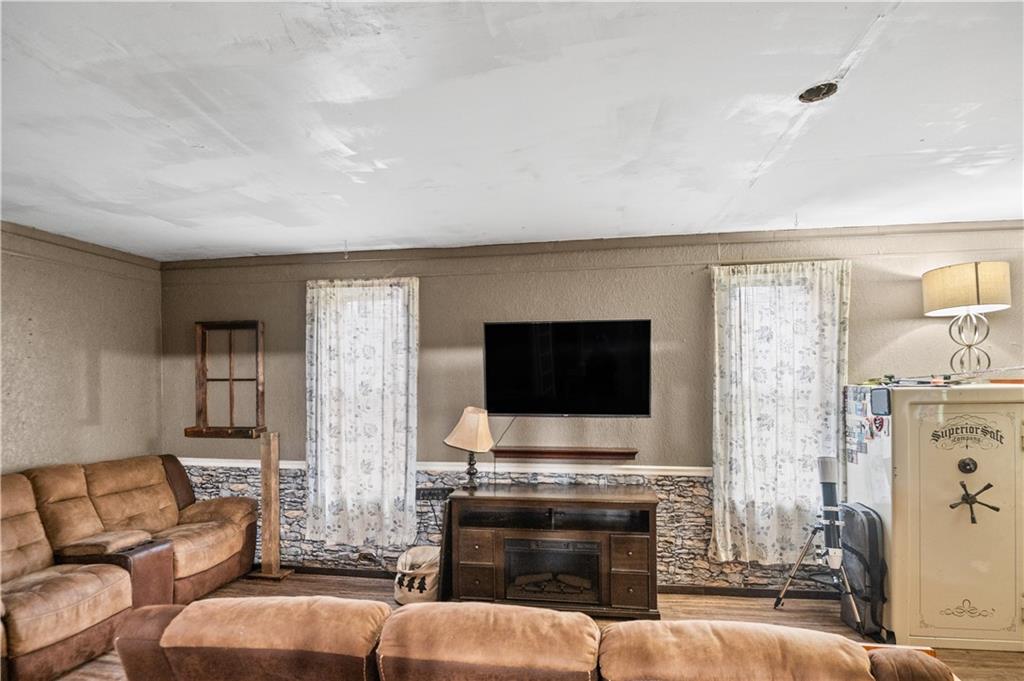 845 Mottern Road Punxsutawney, PA 15767 - Photo 9 of 40 a living room with furniture a flat screen tv and a fireplace