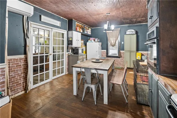a dining room with furniture a chandelier and wooden floor