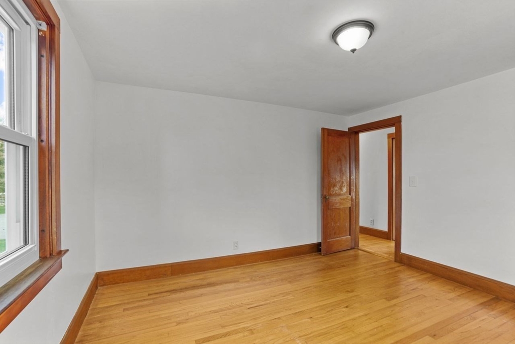 49 Old Stone Church Road Little Compton, RI 02837 - Photo 16 of 27 an empty room with wooden floor and windows