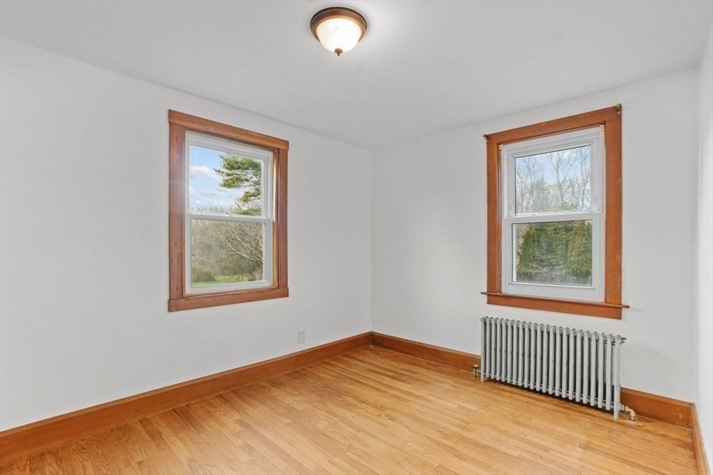 49 Old Stone Church Road Little Compton, RI 02837 - Photo 18 of 27 an empty room with wooden floor and windows