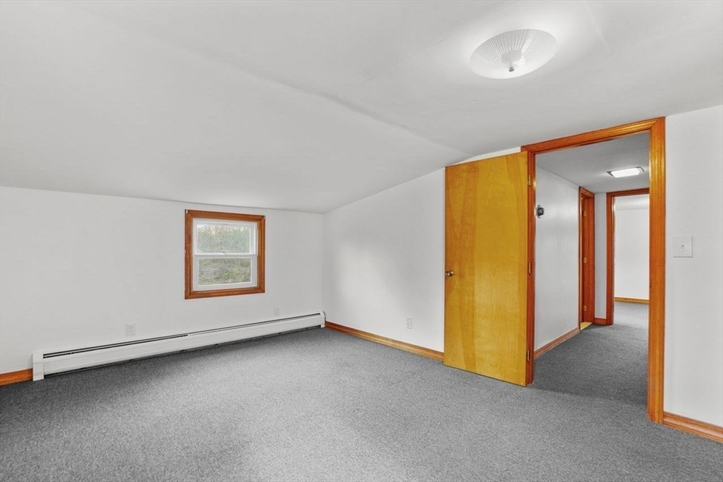 49 Old Stone Church Road Little Compton, RI 02837 - Photo 23 of 27 an empty room with a door and a hallway