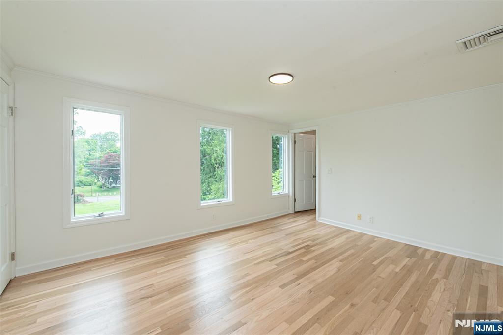 163 Sand Spring Road Morristown, NJ 07960 - Photo 24 of 39 an empty room with wooden floor and windows