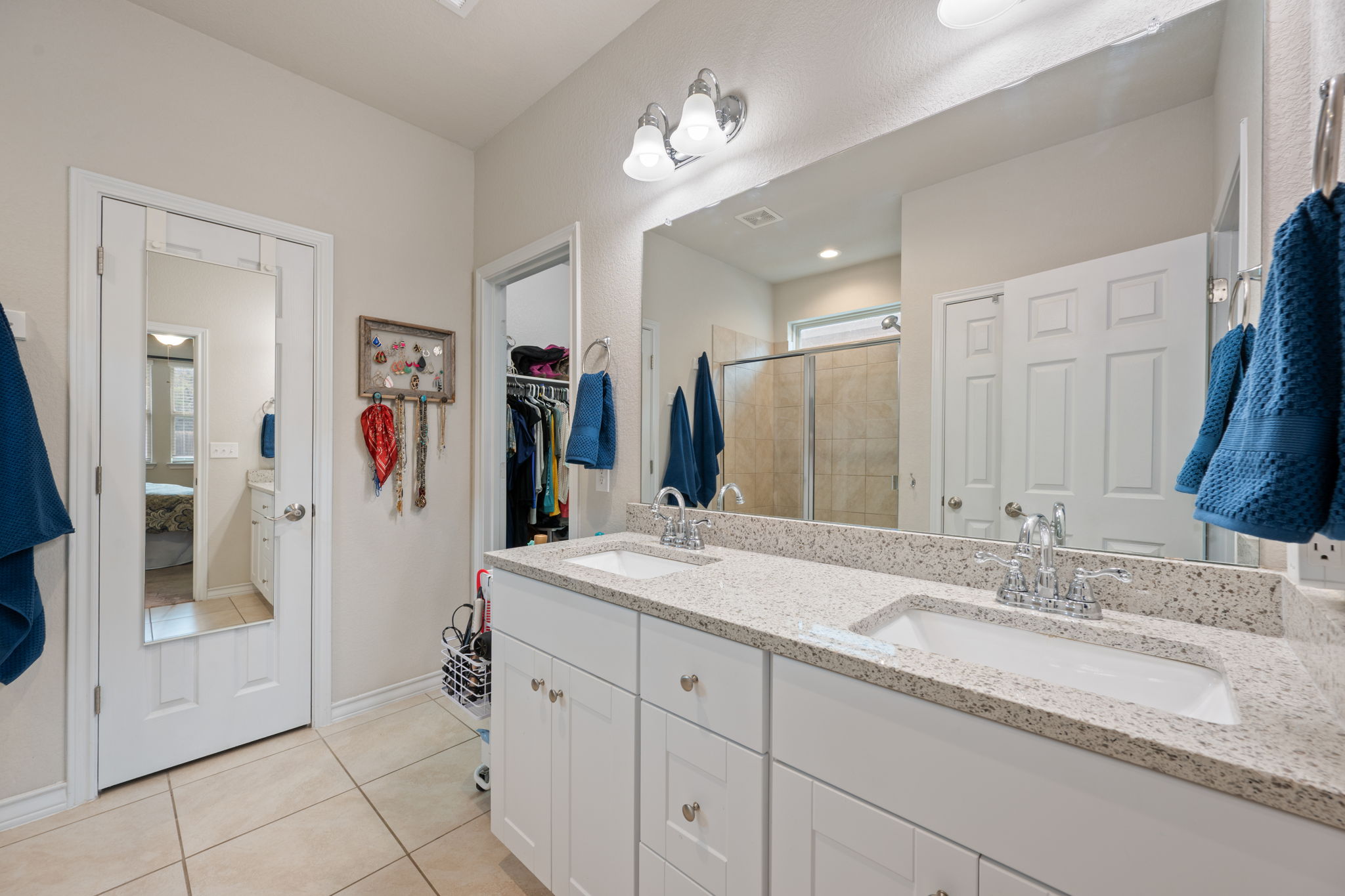 409 Limestone Road Liberty Hill, TX 78642 - Photo 17 of 35 a bathroom with a granite countertop sink and a mirror
